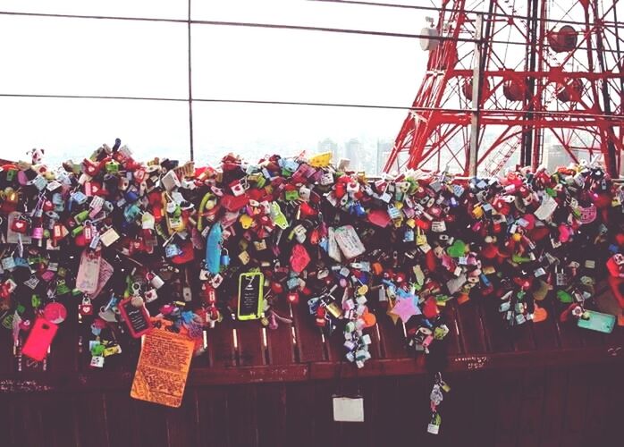 low angle view, hanging, built structure, architecture, building exterior, clear sky, abundance, red, sky, outdoors, large group of people, day, city, flower, growth, tree, large group of objects, variation, decoration, multi colored