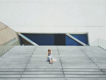 Full length of woman standing by railing