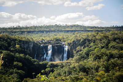 Scenic view of waterfall against sky