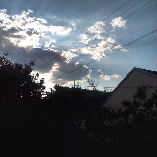 built structure, architecture, sky, building exterior, low angle view, silhouette, house, tree, cloud - sky, power line, cloud, residential structure, nature, outdoors, residential building, sunlight, no people, cloudy, growth, day