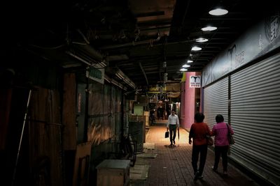 Full length of woman walking in illuminated building