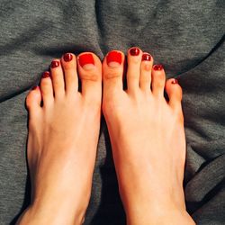 Low section of woman feet on road