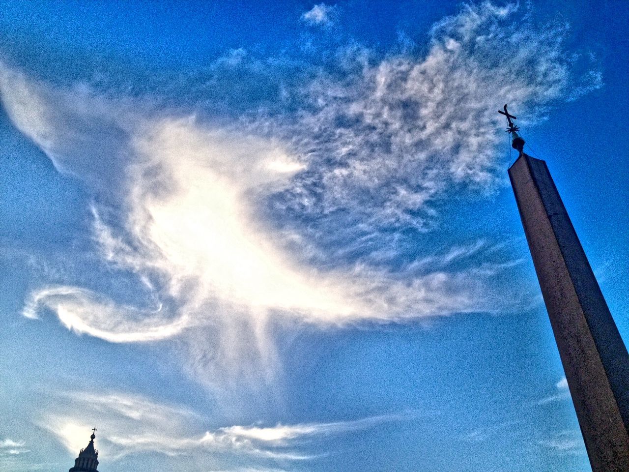 low angle view, blue, built structure, sky, architecture, building exterior, cloud - sky, tower, tall - high, cloud, day, outdoors, no people, sunlight, vapor trail, nature, high section, famous place, travel destinations, tall