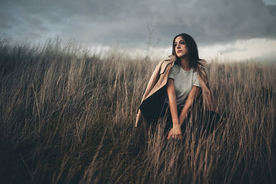 Portrait of a beautiful young woman on field