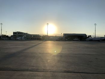 View of airport runway against sky during sunset