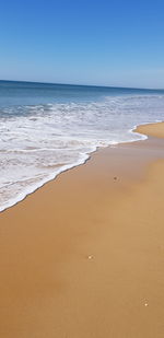 Scenic view of beach against clear sky