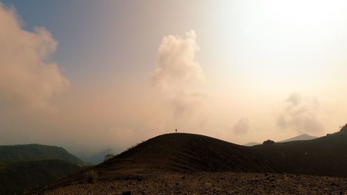 Scenic view of silhouette land against sky during sunset