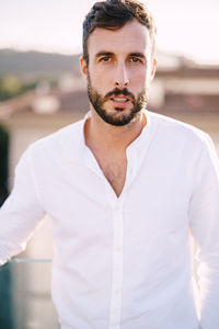 Portrait of young man standing outdoors