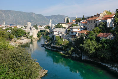 High angle view of river amidst houses in town