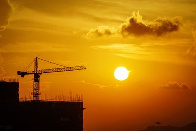 Silhouette of crane at sunset