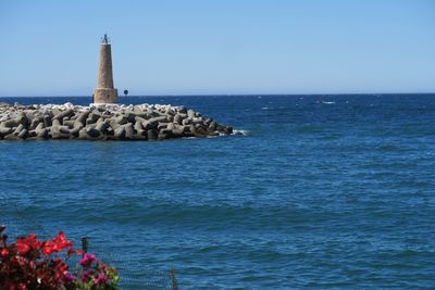 Scenic view of sea against clear blue sky