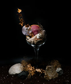 Close-up of wineglass against black background