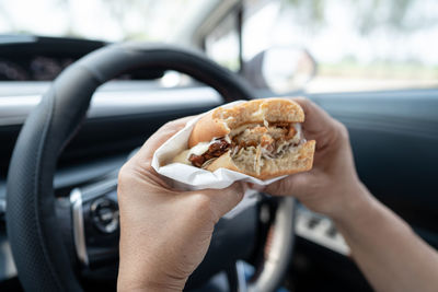 Cropped hand of man holding food