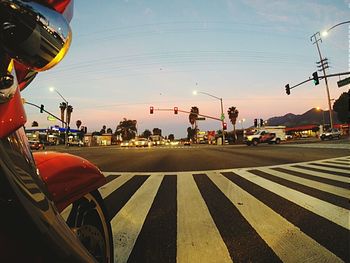 Traffic on road at sunset