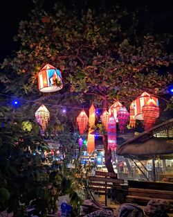 Illuminated lanterns hanging at night in city