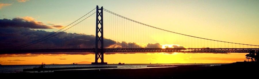 View of suspension bridge against sky during sunset