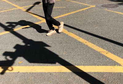 Low section of person walking on zebra crossing