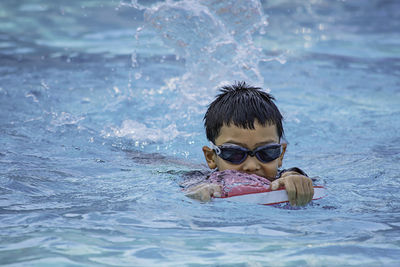 Portrait of boy swimming in pool