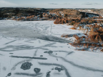 Aerial view of snowcapped landscape against sky