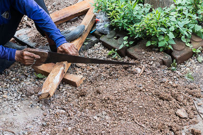 Low section of man working on wood