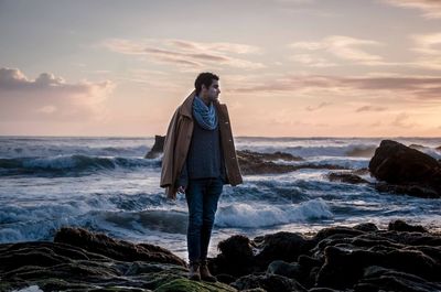 Rear view of man standing on beach