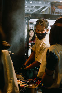 High angle view of people standing in kitchen