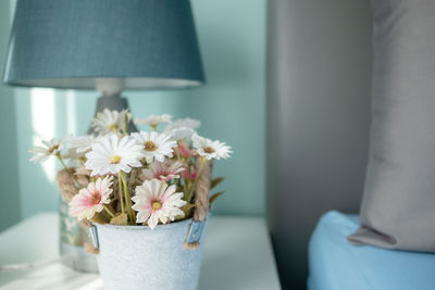 Close-up of white flower vase on table at home