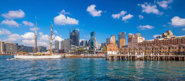 View of buildings in city against cloudy sky