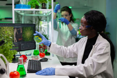 Side view of doctor examining patient in laboratory