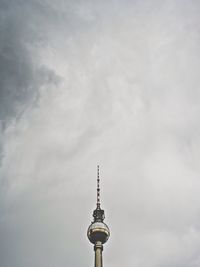 Low angle view of eiffel tower against cloudy sky