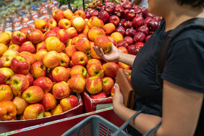 Midsection of man holding fruit