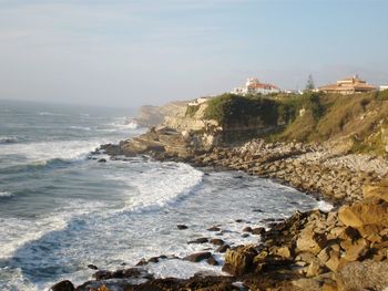 High angle view of cliff by sea against sky