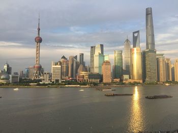 River in city against cloudy sky