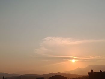 Scenic view of silhouette mountains against sky during sunset