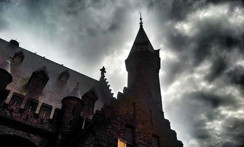 Low angle view of church against cloudy sky