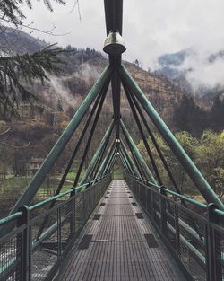 Footbridge against mountain