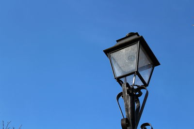 Low angle view of street light against clear blue sky