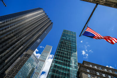 Low angle view of modern buildings against blue sky