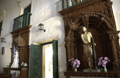 Low angle view of statue against building