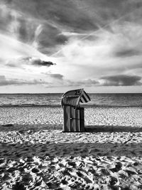 Lifeguard hut on beach against sky