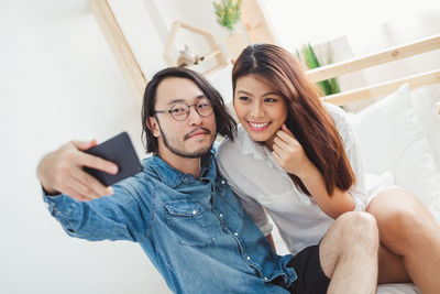 Portrait of young woman using mobile phone