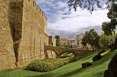 Arch bridge by st georges castle against sky