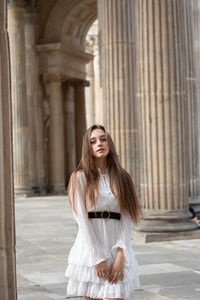 Young woman standing at home