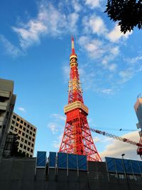 Low angle view of tower against cloudy sky