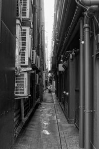 Narrow street amidst buildings in city