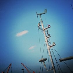 Low angle view of windmill against blue sky