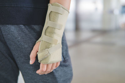 Midsection of man with fractured hand