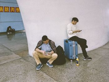 People sitting on wall