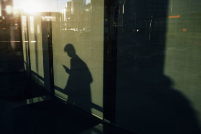 Shadow of man on glass window