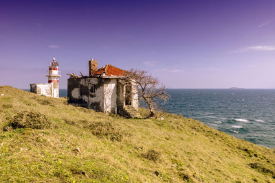 Building by sea against sky